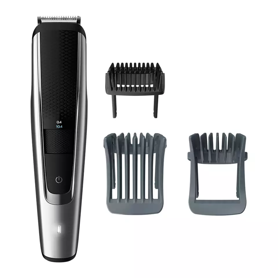 A hair trimmer and comb are next to each other.