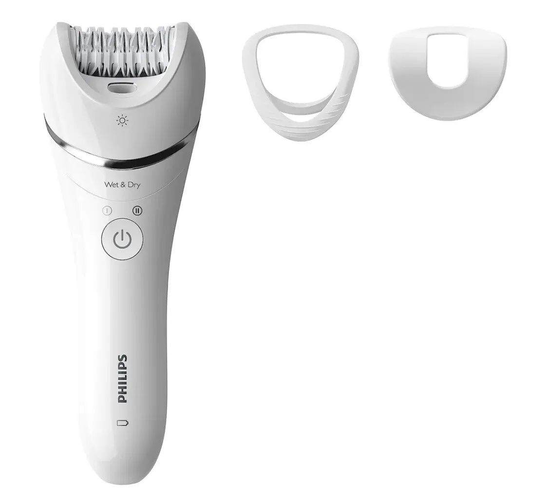 A white electric shaver with three different attachments.