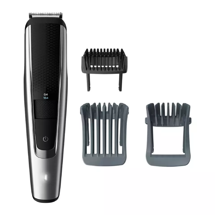 A close up of a hair trimmer and comb