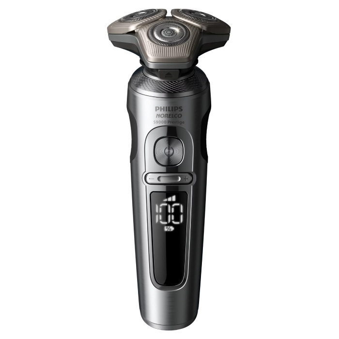 A silver electric razor with an lcd display.
