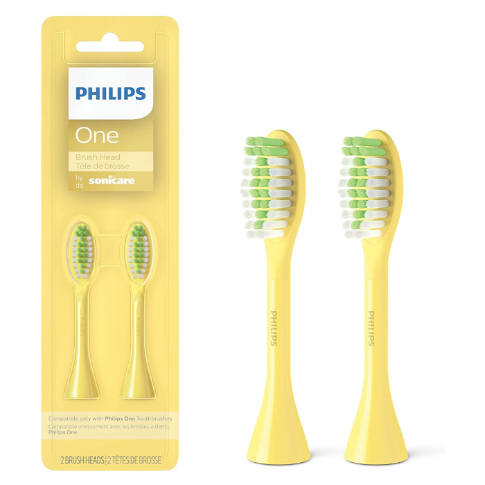 A pair of yellow toothbrush with green bristles.