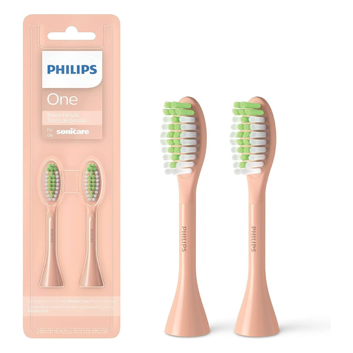 A pair of pink toothbrush heads with green tips.