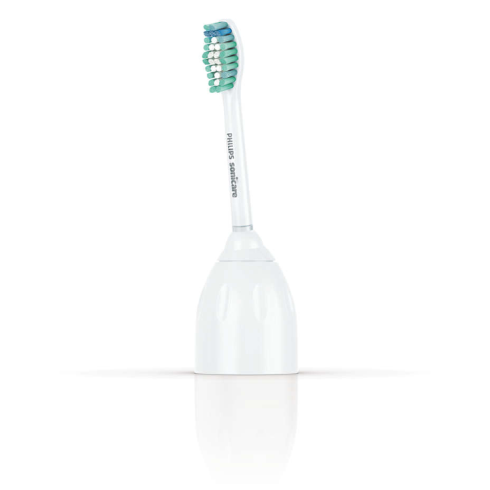 A toothbrush with toothpaste on it is sitting in the water.
