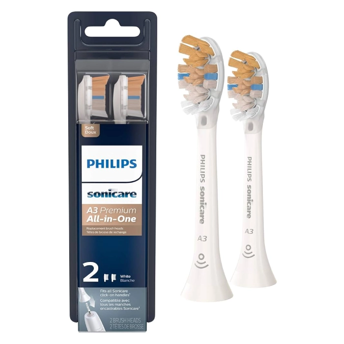 A pair of white and gold toothbrush heads in packaging.