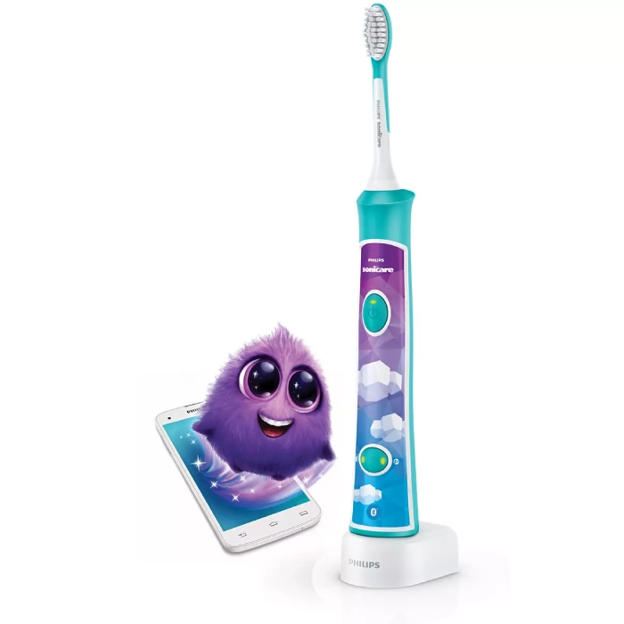 A purple and blue electric toothbrush next to a toy.