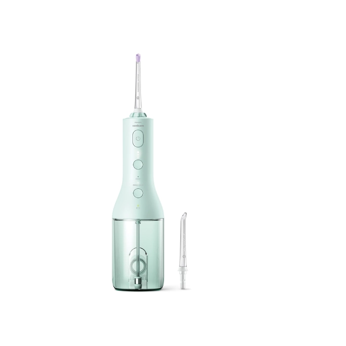 A green electric toothbrush with two different brushes.