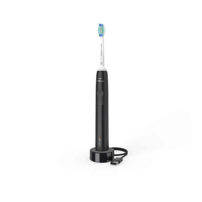 A black electric toothbrush with blue tooth brush on top of it.