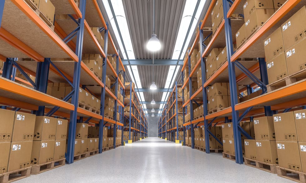 Orderly warehouse aisle lined with stocked pallet racks